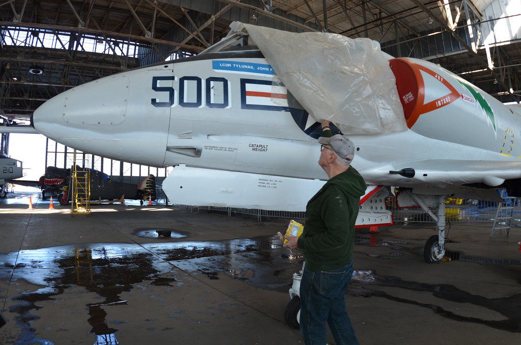 Marty Malone removes rain cover from the Douglas A-4 Skyhawk he has restored<br/>